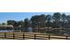 Picturesque pond view surrounded by mature trees; a serene community feature at 784 Sunset Down Ct, Loganville, GA 30052