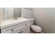 Bathroom vanity with white cabinets, stainless steel faucet, toilet, and framed mirror at 1935 Cutters Mill Way, Lithonia, GA 30058