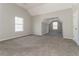 An angled-ceiling bedroom with neutral paint, carpet, and two large windows at 1935 Cutters Mill Way, Lithonia, GA 30058