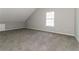Bedroom featuring plush carpet floors, light gray walls, and an arched window at 1935 Cutters Mill Way, Lithonia, GA 30058