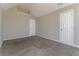 Bedroom showcasing plush carpet floors, light gray walls, and two entry doors at 1935 Cutters Mill Way, Lithonia, GA 30058