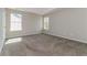 A bedroom with gray walls, carpet floors, and natural light from two windows at 1935 Cutters Mill Way, Lithonia, GA 30058