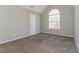 Bedroom showcasing plush carpet floors, light gray walls, and a charming arched window at 1935 Cutters Mill Way, Lithonia, GA 30058