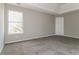 Bedroom featuring light gray walls, plush carpet, and a large window at 1935 Cutters Mill Way, Lithonia, GA 30058