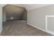 Carpeted bonus room with gray walls, storage nook, and dormer ceilings at 1935 Cutters Mill Way, Lithonia, GA 30058