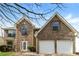 Charming brick two-story home with attached two car garage and manicured lawn at 1935 Cutters Mill Way, Lithonia, GA 30058