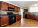 Kitchen featuring dark wood cabinets, black appliances, and tile flooring at 1935 Cutters Mill Way, Lithonia, GA 30058