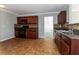 Spacious kitchen with dark cabinets, black appliances, tile floors and view to dining at 1935 Cutters Mill Way, Lithonia, GA 30058
