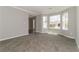 Bright living room with neutral walls, plush carpeting, and large bay windows at 1935 Cutters Mill Way, Lithonia, GA 30058