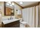 Bathroom with a wooden-framed mirror, vanity, toilet, and shower with a curtain at 2592 Valley Stream Dr, Atlanta, GA 30360