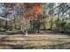 Large, secluded backyard featuring fall foliage from mature trees at 2670 Foxlair Trl, Atlanta, GA 30349