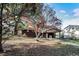 View of the backyard and covered patio, framed by trees in full autumn color at 2670 Foxlair Trl, Atlanta, GA 30349