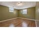 Unfurnished bedroom featuring hardwood floors and two windows at 2670 Foxlair Trl, Atlanta, GA 30349