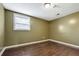 This room features hardwood flooring, a window, and neutral-colored walls at 2670 Foxlair Trl, Atlanta, GA 30349