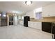 Spacious kitchen with white cabinets, tile flooring, and black appliances at 2670 Foxlair Trl, Atlanta, GA 30349