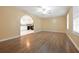 Open-concept living area with hardwood floors, archway, and view into the kitchen at 2670 Foxlair Trl, Atlanta, GA 30349