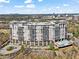 Luxury high-rise building with balconies, surrounded by lush landscaping, trees, and city views in a picturesque setting at 2950 Mount Wilkinson Se Pkwy # 712, Atlanta, GA 30339