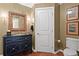 Elegant powder room with custom vanity, framed mirror, and classic design elements at 2950 Mount Wilkinson Se Pkwy # 712, Atlanta, GA 30339