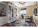 Well-lit office with custom built-ins, hardwood floors, and a comfortable seating area at 2950 Mount Wilkinson Se Pkwy # 712, Atlanta, GA 30339