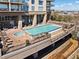 Stunning rooftop pool and hot tub with lounge chairs, tables, and city views in a modern high-rise building at 2950 Mount Wilkinson Se Pkwy # 712, Atlanta, GA 30339