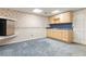 Partially finished basement with a mini-kitchen area and blue carpet at 3401 Doyle Sw Ln, Marietta, GA 30060