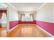 Elegant dining room with hardwood floors, decorative wallpaper, and a chandelier, ideal for Gathering gatherings at 3401 Doyle Sw Ln, Marietta, GA 30060