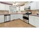 Classic white kitchen featuring stainless steel appliances and a mosaic backsplash at 3401 Doyle Sw Ln, Marietta, GA 30060