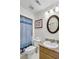 Cozy bathroom with granite countertops, toilet, and shower with blue patterned curtain at 6730 Gallant Se Ct, Mableton, GA 30126