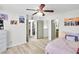 Bedroom featuring a ceiling fan, hardwood floors, walk-in closet and neutral walls at 6730 Gallant Se Ct, Mableton, GA 30126