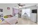 Bright bedroom with a ceiling fan, hardwood floors, decorated walls, and a large window for natural light at 6730 Gallant Se Ct, Mableton, GA 30126