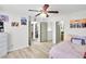Bedroom with light hardwood floors, ceiling fan, and access to walk-in closet at 6730 Gallant Se Ct, Mableton, GA 30126
