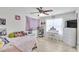 Bedroom with light hardwood floors, a ceiling fan, and large window providing natural light at 6730 Gallant Se Ct, Mableton, GA 30126