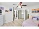 Bright and airy bedroom with a ceiling fan, open closet, and wooden floors at 6730 Gallant Se Ct, Mableton, GA 30126