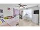 Bright bedroom with desk area and plush decor, illuminated by a ceiling fan at 6730 Gallant Se Ct, Mableton, GA 30126