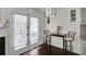 Bright dining area with French doors, dark hardwood floors, and modern lighting at 6730 Gallant Se Ct, Mableton, GA 30126