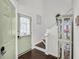 Bright entryway with a view of the stairs, front door, and an elegant display cabinet at 6730 Gallant Se Ct, Mableton, GA 30126