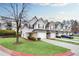 View of townhomes with attached garages, manicured lawns, and convenient parking at 6730 Gallant Se Ct, Mableton, GA 30126