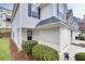 Exterior angle view of a townhome with attached garage, landscaping, and side entrance at 6730 Gallant Se Ct, Mableton, GA 30126
