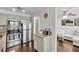 Open concept kitchen with stainless steel appliances, light green cabinetry, and access to living area at 6730 Gallant Se Ct, Mableton, GA 30126
