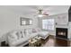 Cozy living room with a fireplace, plush sofa, and natural light streaming in at 6730 Gallant Se Ct, Mableton, GA 30126