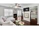 Cozy living room with fireplace, wood floors, and access to kitchen at 6730 Gallant Se Ct, Mableton, GA 30126