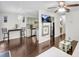 Open floor plan connecting living room, dining area, and kitchen with hardwood floors at 6730 Gallant Se Ct, Mableton, GA 30126