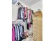 Organized walk-in closet with hanging rods, shelves, and a dresser for optimal storage solutions, featuring light flooring at 6730 Gallant Se Ct, Mableton, GA 30126