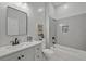 Modern bathroom features a gray vanity, white subway tile, and a shower-tub combo at 6971 Tan Bark Ct, Riverdale, GA 30296