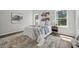 Bright bedroom featuring multiple windows, neutral decor, and hardwood floors at 6971 Tan Bark Ct, Riverdale, GA 30296