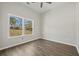 Neutral bedroom featuring new flooring and two windows for abundant natural light at 6971 Tan Bark Ct, Riverdale, GA 30296