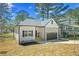 Charming single-Gathering home with stone accents, attached garage, and newly landscaped front yard at 6971 Tan Bark Ct, Riverdale, GA 30296