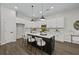 Modern kitchen features stainless appliances, white cabinets and a stylish island with seating at 6971 Tan Bark Ct, Riverdale, GA 30296