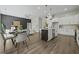 Open floor plan featuring a modern kitchen with island seating, dining area, and cozy living space at 6971 Tan Bark Ct, Riverdale, GA 30296