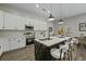 Bright eat-in kitchen featuring stainless appliances, white cabinets and island seating at 6971 Tan Bark Ct, Riverdale, GA 30296